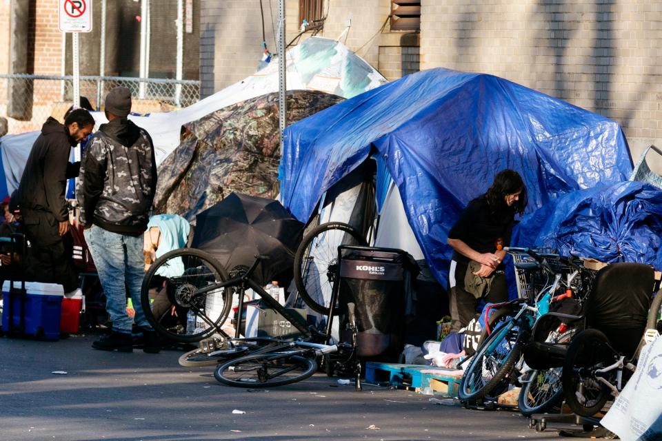 Tents of a homeless camp line the sidewalk in 2021 in Boston.