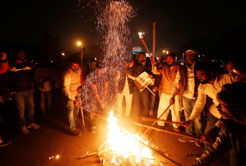 Members of the youth wing of India's main opposition Congress party burn a copy of Citizenship Amendment Bill during a protest in New Delhi