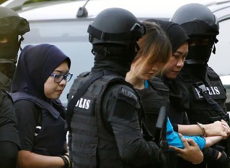 Vietnamese Doan Thi Huong, who is charged for the murder of Kim Jong Nam, is escorted by police as she arrives at a Sepang court, in Malaysia April 13, 2017. REUTERS/Lai Seng Sin