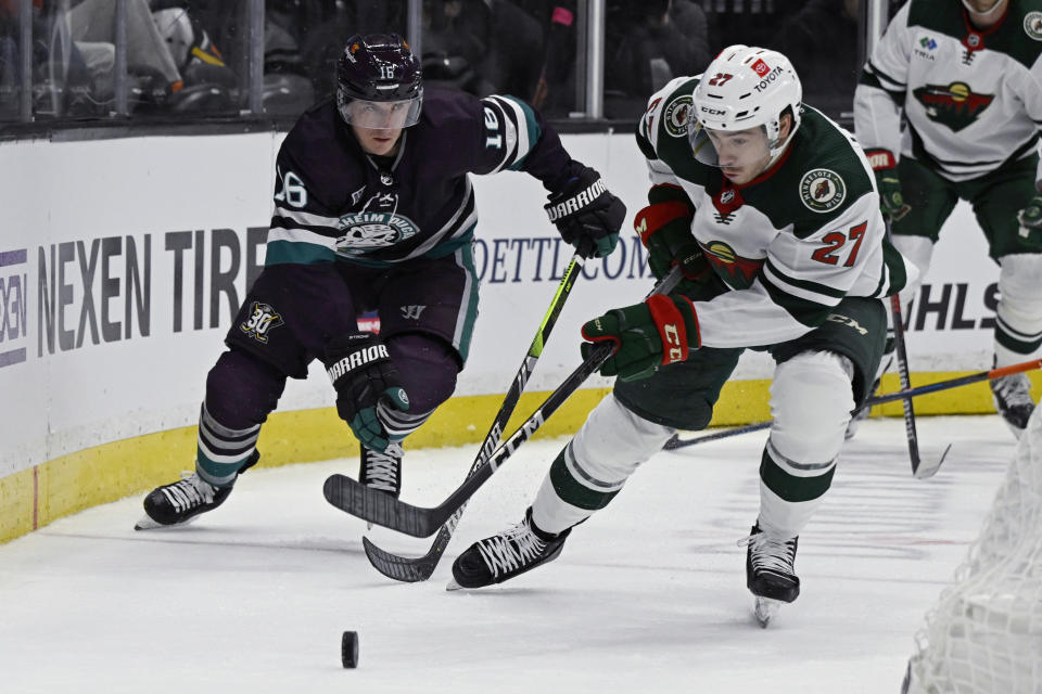 Minnesota Wild center Jacob Lucchini (27) takes the puck away from Anaheim Ducks center Ryan Strome (16) during the third period of an NHL hockey game in Anaheim, Calif., Tuesday, March 19, 2024. (AP Photo/Alex Gallardo)