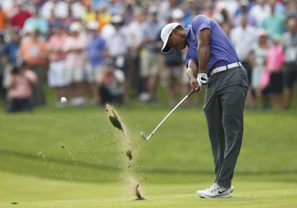 Tiger Woods of the U.S. hits his approach shot on the 12 hole during the first round of the PGA Championship at Valhalla Golf Club in Louisville, Kentucky, August 7, 2014. REUTERS/John Sommers II