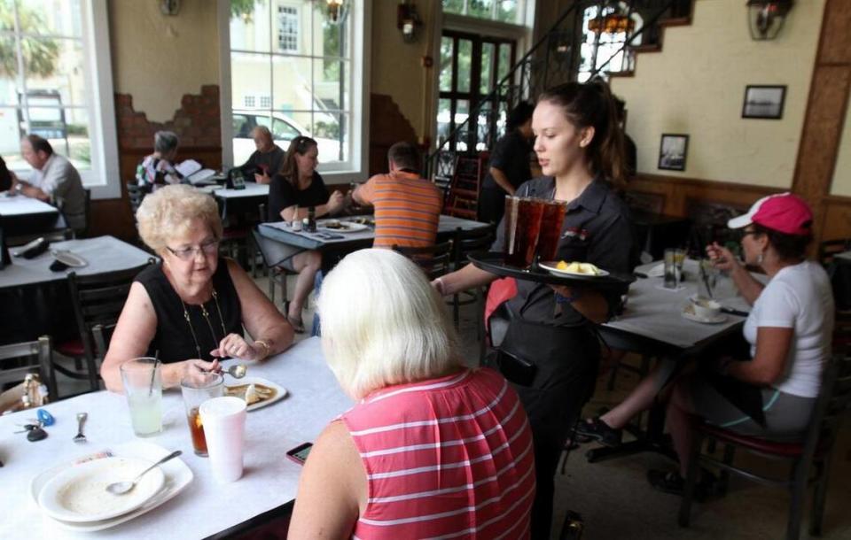 Kaytlin McCormick of Ocean Springs serves Juanita Moore, left, and Joyce Addison, both of Latimer, at Half Shell Oyster House restaurant in Biloxi on Monday, Aug. 8, 2016.