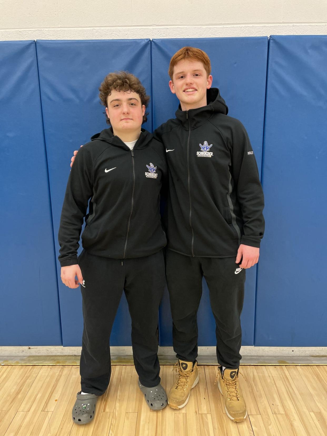 Webster Schroeder guards Anthony DeRosa, left, and Jacob Insley after a 57-46 win over Brighton on Wednesday, Jan. 17, 2024.