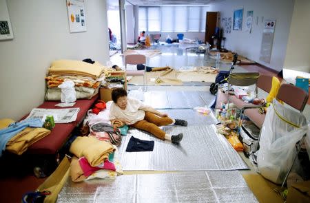 An evacuee takes rest at Mabi Clean Center, acting as a evacuation center, in Kurashiki, Okayama Prefecture, Japan, July 13, 2018. REUTERS/Issei Kato
