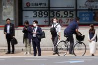 People stand in front of an electronic stock board showing Japan's Nikkei 225 index at a securities firm Thursday, June 6, 2024, in Tokyo. (AP Photo/Eugene Hoshiko)