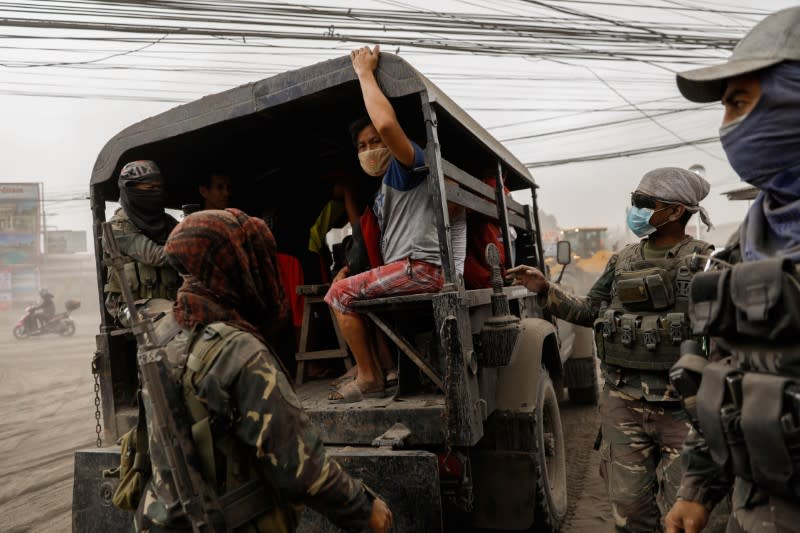 Residents living near the errupting Taal Volcano evacuate in Lemery, Batangas City