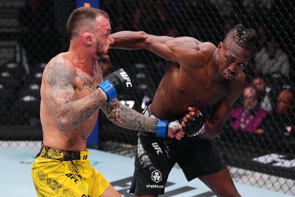 LAS VEGAS, NEVADA - APRIL 13: (R-L) Jalin Turner punches Renato Moicano of Brazil in a lightweight fight during the UFC 300 event at T-Mobile Arena on April 13, 2024 in Las Vegas, Nevada. (Photo by Jeff Bottari/Zuffa LLC via Getty Images)