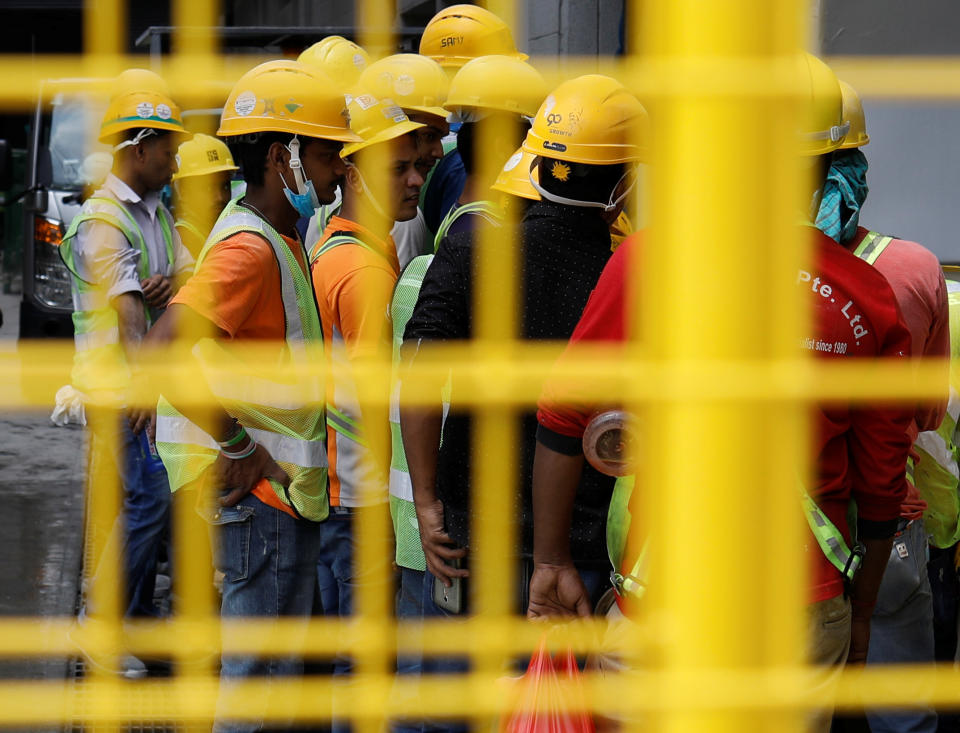 Construction workers gather around a tap to wash their hands as they break for lunch in Singapore March 5, 2019. Picture taken March 5, 2019. REUTERS/Edgar Su