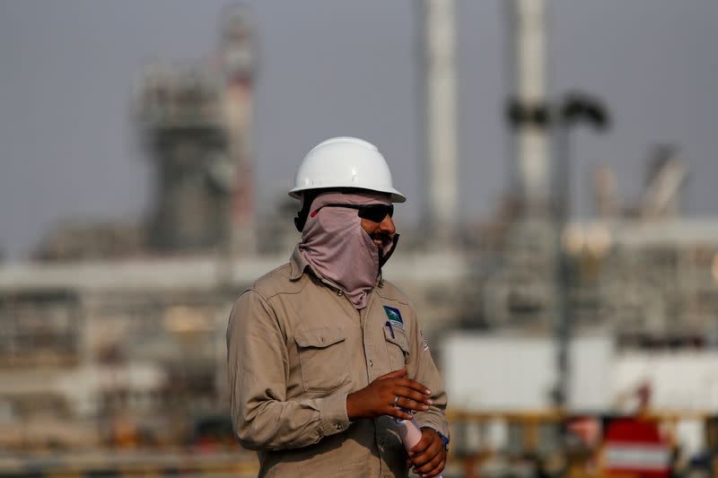 FILE PHOTO: An employee looks on at Saudi Aramco oil facility in Abqaiq