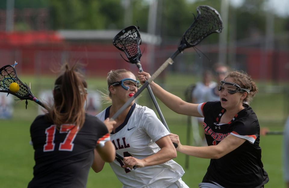 Wall Rory Paris finds herself in traffic but still manages to shoot and score in first half action. Wall defeats Barnegat 13-8 in NJSIAA Girls Lacrosse in Wall, NJ on May 20, 2022. 