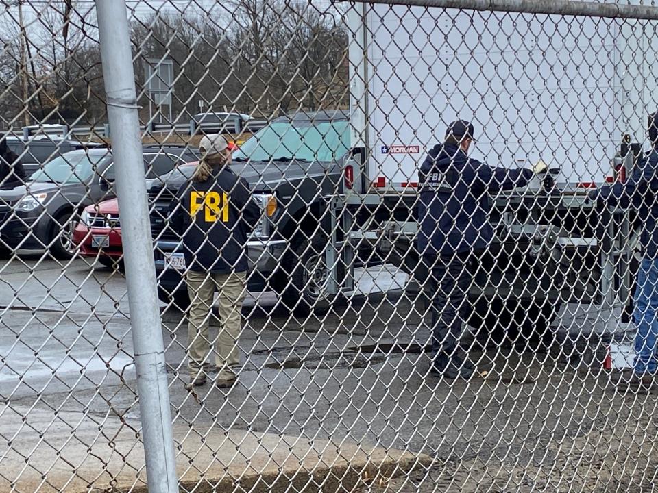 FBI agents secure a truckload of materials seized from Accurate Converter off Branch Avenue in Providence on Thursday.