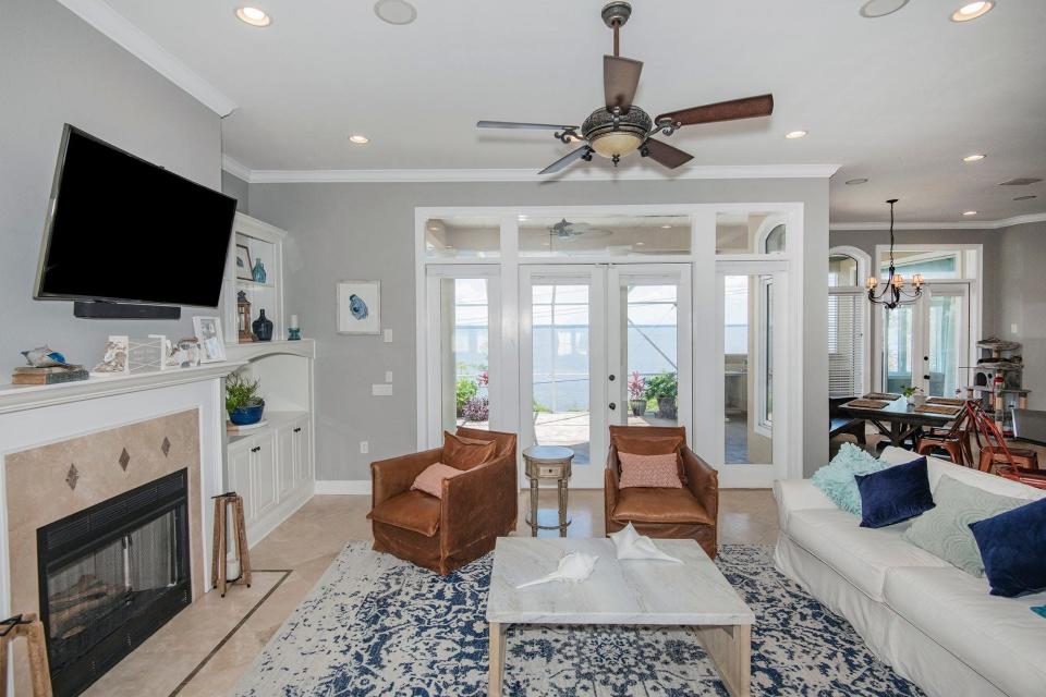 The main living area opens to the pool and overlooks the waterfront.