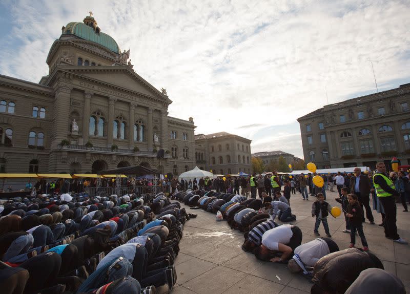 FILE PHOTO: Muslim men pray in front of the Swiss Federal Palace during a protest against islamophobia and racism in Bern