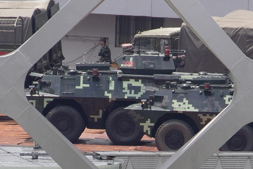 Armored carriers line up during drills at the Shenzhen Bay Stadium in Shenzhen in Southern China's Guangdong province on Sunday, Aug. 18, 2019. A spokesman for China's ceremonial legislature has condemned statements from U.S. lawmakers supportive of Hong Kong's pro-democracy movement. (AP Photo/Ng Han Guan)