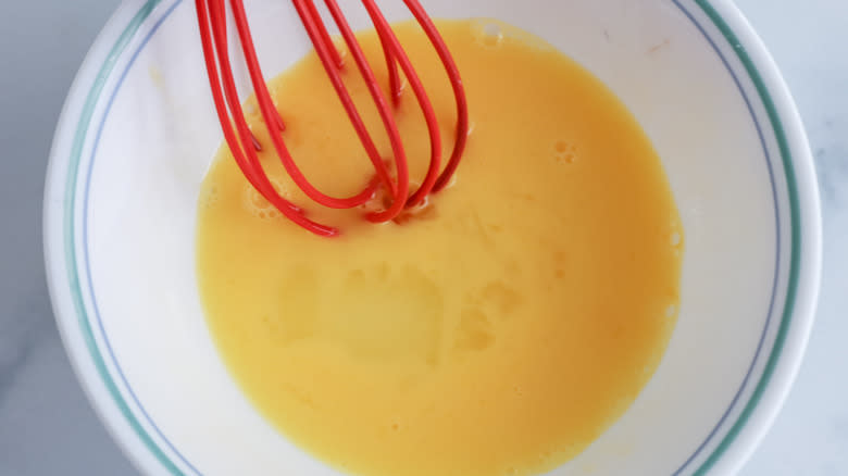 whisking egg wash in bowl