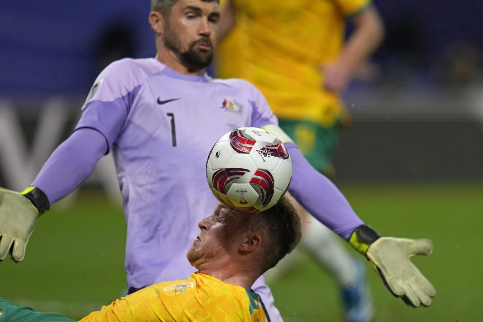 Australia's Harry Souttar, bottom, makes a save as Australia's goalkeeper Mathew Ryan challenges during the Asian Cup quarterfinal soccer match between Australia and South Korea at Al Janoub Stadium in Al Wakrah, Qatar, Friday, Feb. 2, 2024. (AP Photo/Aijaz Rahi)