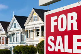 Dreaming of buying one of those colorful iconic San Francisco row houses. For Sale sign is visible in front.