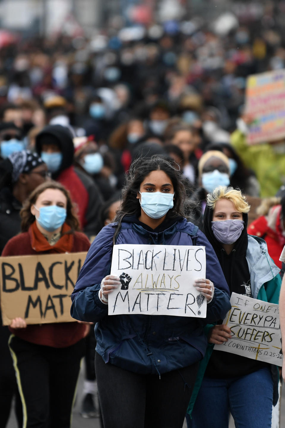 Demonstrators, some wearing PPE (personal protective equipment), including a face mask as a precautionary measure against COVID-19,  hold placards as they attend a protest march to the US Embassy in London on June 6, 2020, to show solidarity with the Black Lives Matter movement in the wake of the killing of George Floyd, an unarmed black man who died after a police officer knelt on his neck in Minneapolis. - The United States braced Friday for massive weekend protests against racism and police brutality, as outrage soared over the latest law enforcement abuses against demonstrators that were caught on camera. With protests over last week's police killing of George Floyd, an unarmed black man, surging into a second weekend, President Donald Trump sparked fresh controversy by saying it was a "great day" for Floyd. (Photo by DANIEL LEAL-OLIVAS / AFP) (Photo by DANIEL LEAL-OLIVAS/AFP via Getty Images)