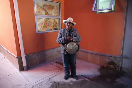 A musician stands with his instrument at Reynaldo Llanqui's home after a wedding party in the town of Nueva Fuerabamba in Apurimac, Peru, October 2, 2017. REUTERS/Mariana Bazo