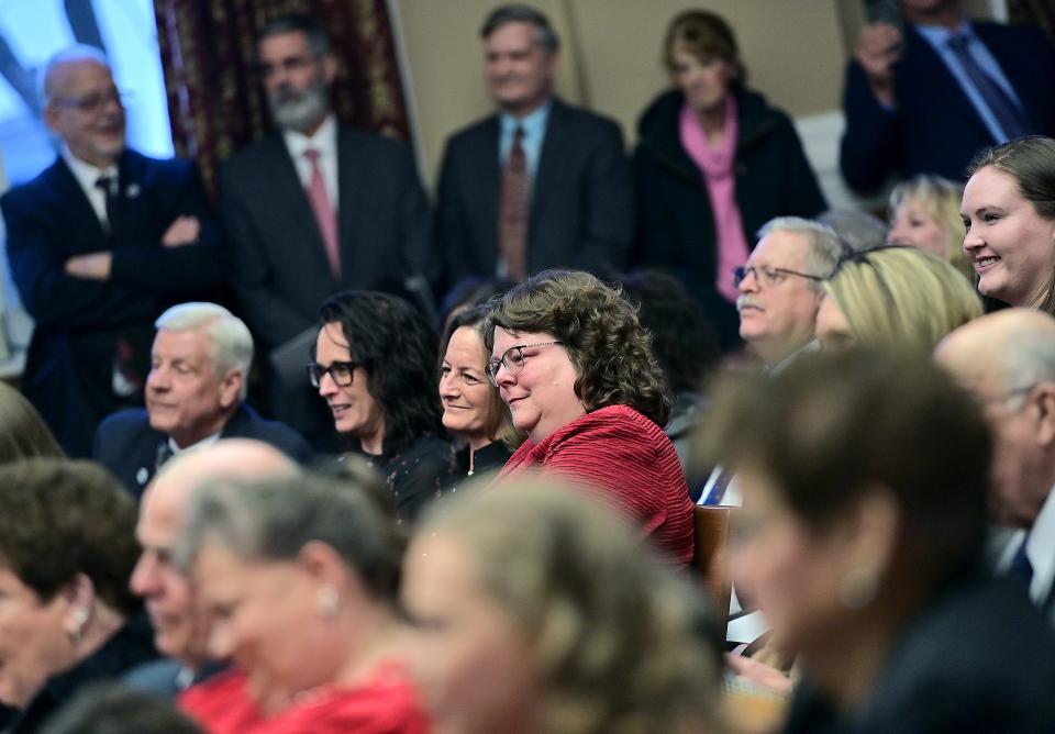 Eileen Downey, right in red, sits with Stephanie Wilkinson after Kirk C. Downey is welcomed to the bench as associate judge of Washington County Circuit Court on Friday during a ceremony in the old courthouse in downtown Hagerstown.