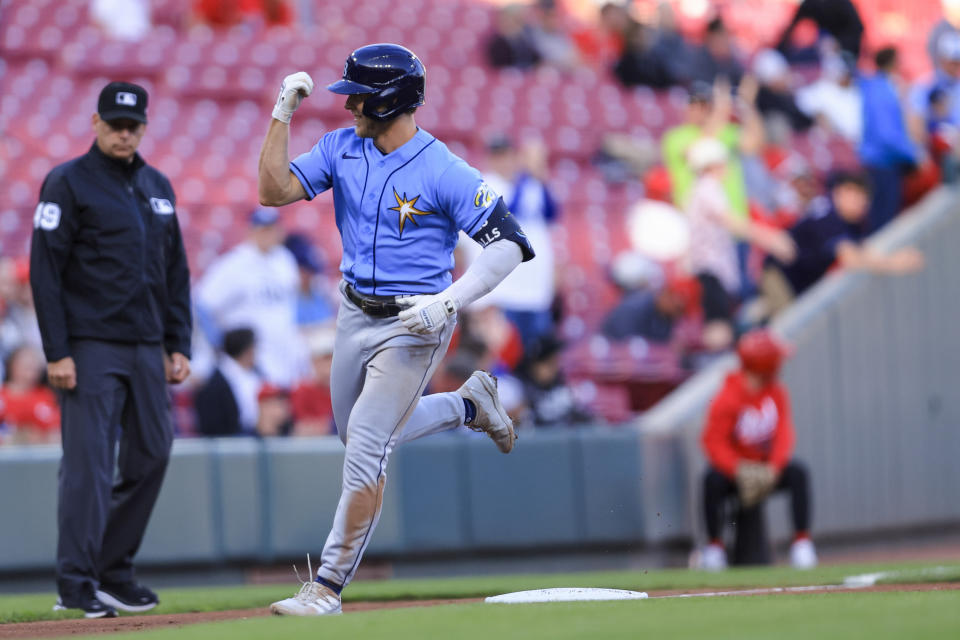 Tampa Bay Rays' Taylor Walls gestures to the dugout as he runs the bases on a solo home run during the second inning of the team's baseball game against the Cincinnati Reds in Cincinnati, Tuesday, April 18, 2023. (AP Photo/Aaron Doster)