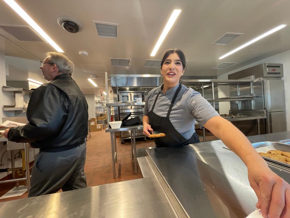 A staff member hands out free cookies to visitors inside the industrial kitchen of the city of Victorville's Wellness Center for the homeless. City officials and a host of dignitaries on Friday, Dec. 8. celebrated the ribbon-cutting of the city-owned facility located north of the railroad tracks in downtown.