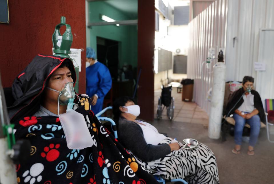 COVID-19 patients wait for space at the entrance to the Villa Elisa Hospital in Villa Elisa, Paraguay, Monday, April 26, 2021. (AP Photo/Jorge Saenz)