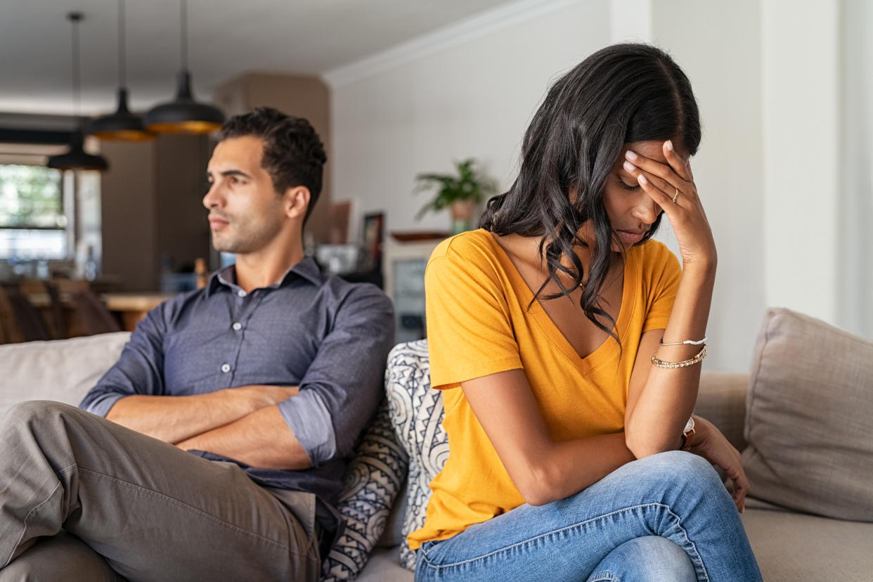 Young couple having a fight at home, facing different directions. 