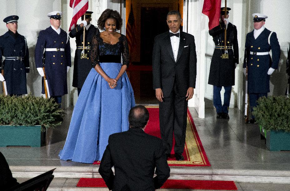 First lady Michelle Obama, left, and President Barack Obama welcome French President François Hollande for a State Dinner at the North Portico of the White House on Tuesday, Feb. 11, 2014, in Washington. (AP Photo/ Evan Vucci)