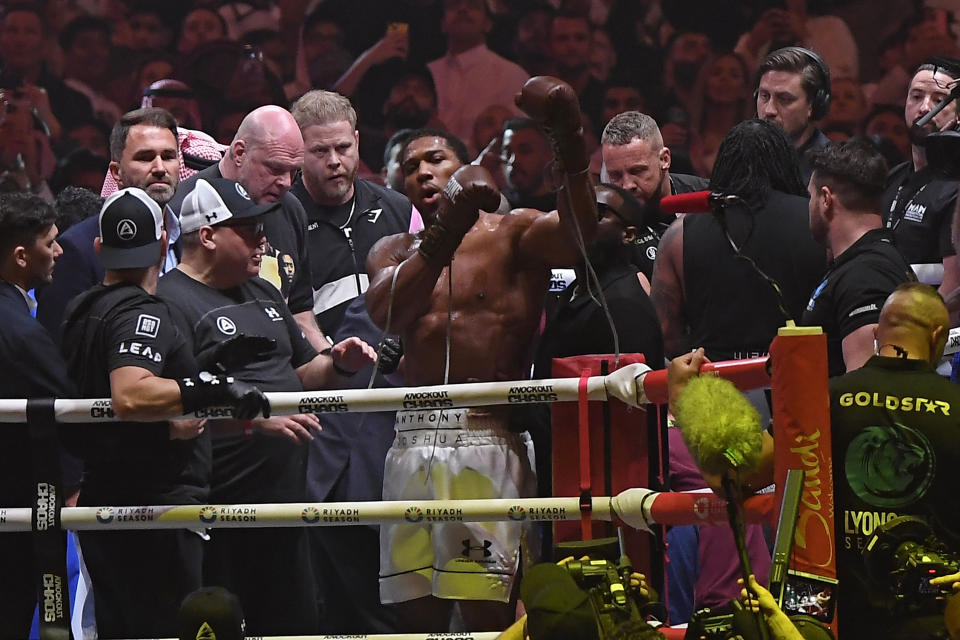 British former world champion Anthony Joshua, center, celebrates after winning the fight against Francis Ngannou during the heavyweight boxing showdown at Kingdom Arena in Riyadh, Saudi Arabia, Saturday, March 9, 2024. (AP Photo)