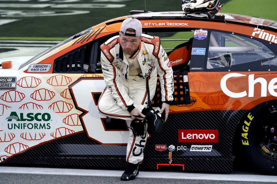 Tyler Reddick gets ready next to his car before the NASCAR Cup Series auto race at Daytona International Speedway, Saturday, Aug. 28, 2021, in Daytona Beach, Fla. (AP Photo/John Raoux)