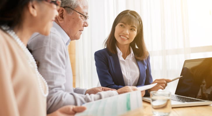 A financial advisor talks with a couple about revocable beneficiries.