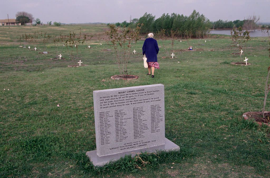 elderly woman at memorial for deceased branch davidians