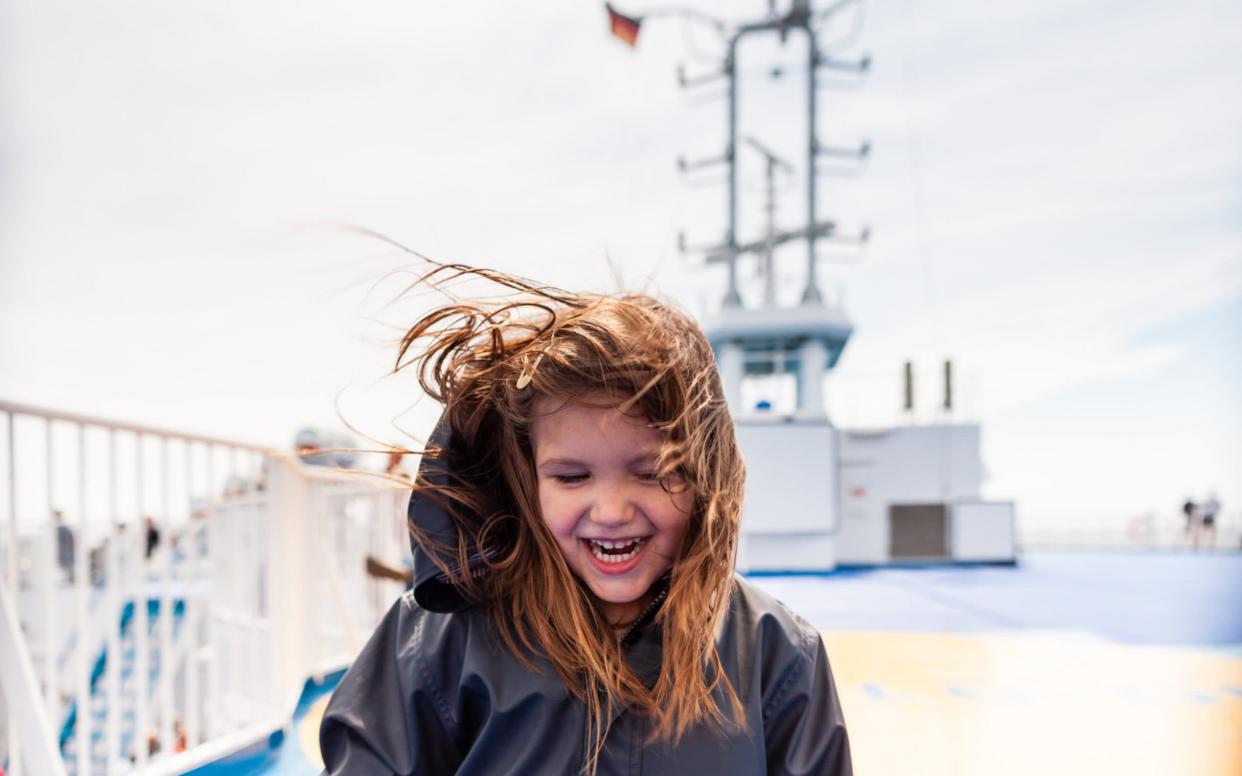 Toddler girl's portrait on ferry deck in windy weather  - Digital Vision 