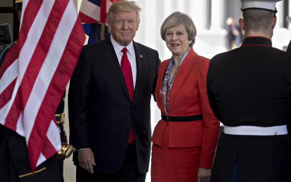 Donald Trump stands with Theresa May - Credit: Andrew Harrer/Bloomberg