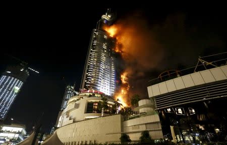 A fire engulfs the Address Hotel in downtown Dubai in the United Arab Emirates in this December 31, 2015 file photo. REUTERS/Ahmed Jadallah/Files