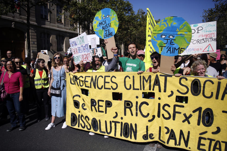 Protestors march during a climate demonstration, in Paris, Saturday, Sept. 21, 2019. Scuffles broke out in Paris between some violent activists and police which responded with tear gas at a march for climate gathering thousands of people in Paris. (AP Photo/Thibault Camus)