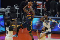 Golden State Warriors forward Andrew Wiggins (22) shoots against the Minnesota Timberwolves during the first half of an NBA basketball game in San Francisco, Monday, Jan. 25, 2021. (AP Photo/Jeff Chiu)