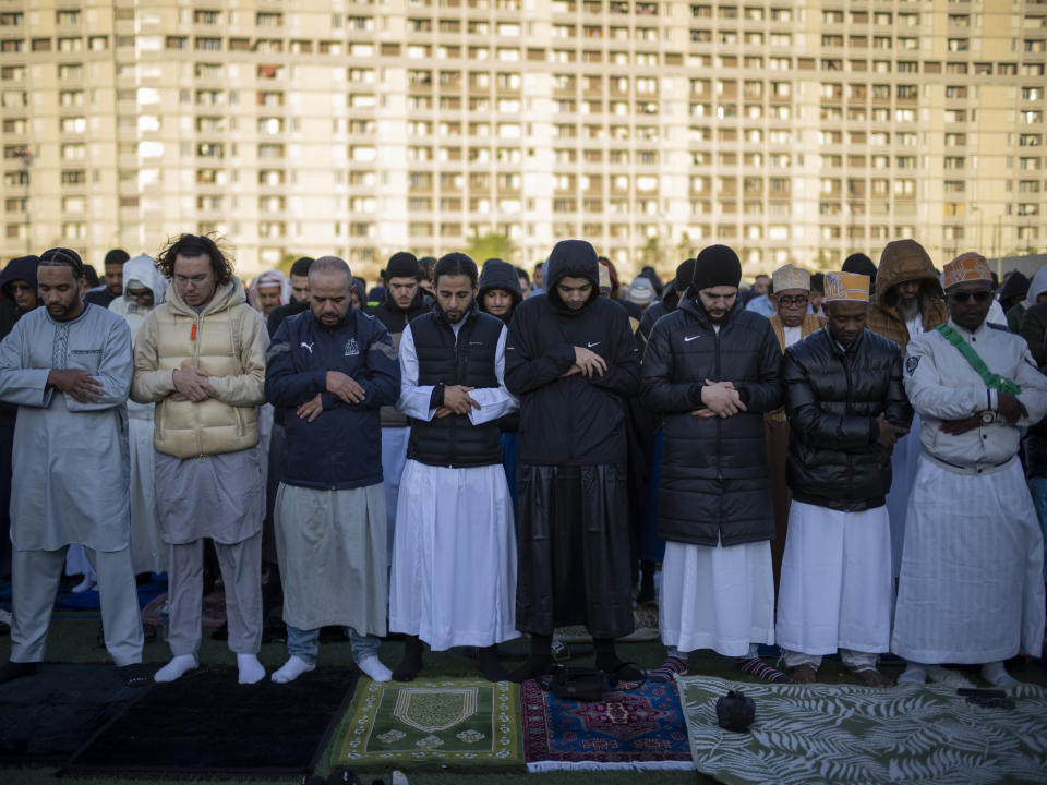 Muslim worshippers offer Eid al-Fitr prayers marking the end of the holy fasting month of Ramadan at the Malpasse soccer stadium in Marseille, southern France, Wednesday, April 10, 2024. (AP Photo/Daniel Cole)