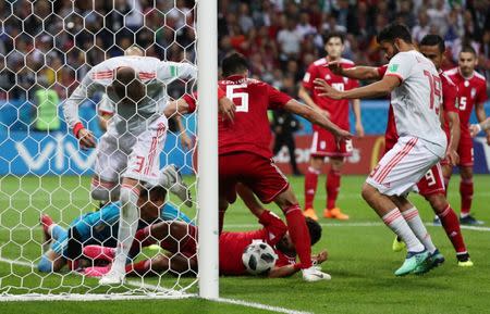 Soccer Football - World Cup - Group B - Iran vs Spain - Kazan Arena, Kazan, Russia - June 20, 2018 Spain's Diego Costa and Gerard Pique in action with Iran's Saeid Ezatolahi and Ramin Rezaeian on the goal line REUTERS/Sergio Perez