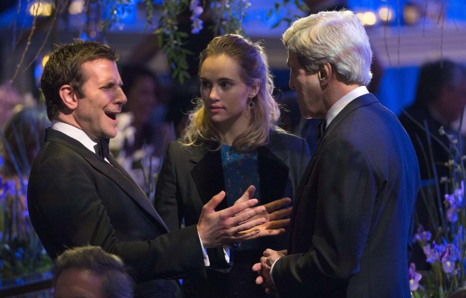 Actor Bradley Cooper and actress Suki Waterhouse talk with U.S. Secretary of State John Kerry (R) during the State Dinner in honor of French President Franois Hollande at the White House in Washington February 11, 2014. (REUTERS/Kevin Lamarque)