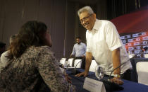 Sri Lankan presidential candidate and former defense chief Gotabaya Rajapaksa speaks with a journalist after a news conference in Colombo, Sri Lanka, Tuesday, Oct. 15, 2019. Rajapaksa, who's a front-runner in next month's presidential election says if he wins he won't recognize an agreement the government made with the U.N. human rights council to investigate alleged war crimes during the nation's civil war. (AP Photo/Eranga Jayawardena)