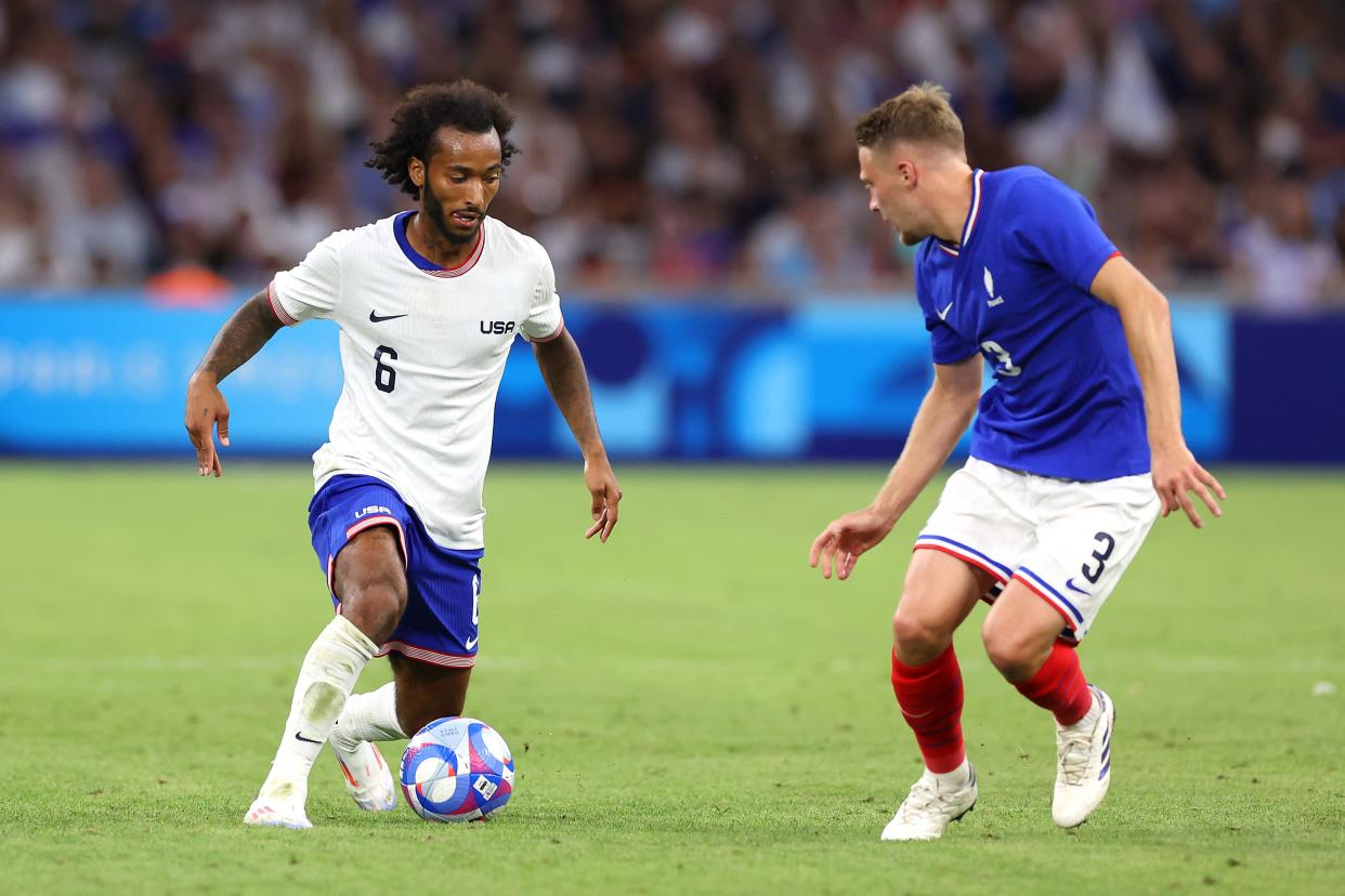 MARSEILLE, FRANCE - JULY 24: Gianluca Busio #6 of Team United States runs with the ball under pressure from Adrien Truffert #3 of Team France during the group A match between France and United States during the Olympic Games. (Photo by Alex Livesey/Getty Images)