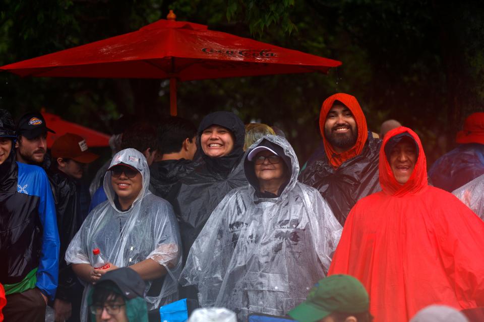 Fans look on during a weather delay before the start of the Grant Park 220 NASCAR Cup Series race Sunday in downtown Chicago.