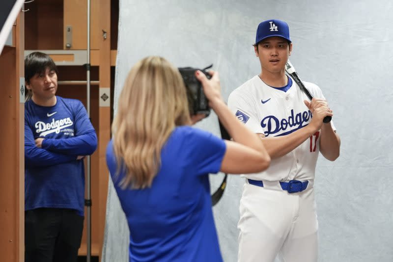 Los Angeles Dodgers Shohei Ohtani poses for a portrait during a spring training baseball team photo day at Camelback Ranch in Phoenix, Wednesday, Feb. 21, 2024. His interpreter, Ippei Mizuhara, is at left. (AP Photo/Ashley Landis)