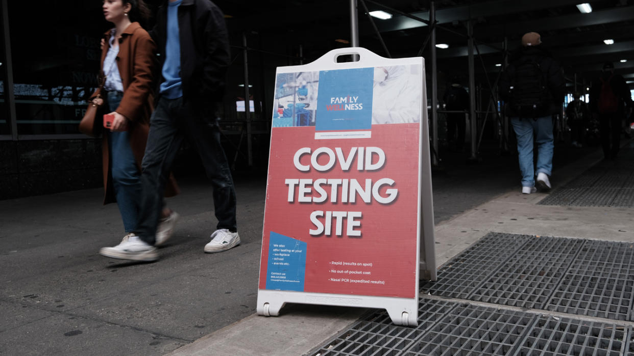 A sign on a city street reads: COVID testing site.