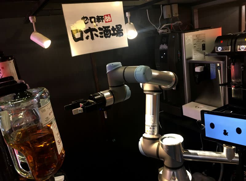 A robot bartender moves its arm to make a cocktail at Japanese style bar Izakaya chain "Yoronotaki" in Tokyo