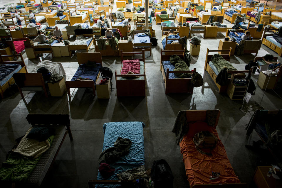 Beds are lined up in a hangar Oct. 8, 2014, at Avon Park Air Force Range, Fla. During Moody's Wing Readiness Inspection, more than 200 Airmen deployed to Avon Park and lived in close quarters after duty hours.