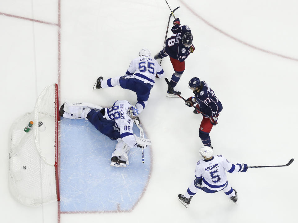 Tampa Bay Lightning's Andrei Vasilevskiy, left, of Russia, gives up a goal as Columbus Blue Jackets' Pierre-Luc Dubois, center, and Josh Anderson watch the play during the second period of Game 3 of an NHL hockey first-round playoff series Sunday, April 14, 2019, in Columbus, Ohio. (AP Photo/Jay LaPrete)