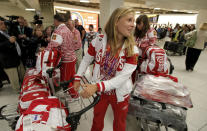 Russian Olympic sailing team athlete Tatiana Bazyuk, centre, and other team members arrive at Heathrow Airport Monday, July 16, 2012, as athletes from all over the world arrive to prepare for the 2012 Summer Olympics. (AP Photo/Charlie Riedel)